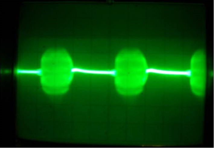 Oscillograph of the both transistors collector voltage in the physical model of the system (7) corresponding to the interaction process between two FPU recurrences corresponding to the interaction dynamics of the electron current Ielectron . and that of the phonon current Iphonon. Corresponds to prevailing of the electron current. The pulses have a complex intrinsic structure of the high frequency FPU recurrence (few Gigahertz). Vert axis 1.5 μ sec/cm, Horiz axis-1volt per cm.