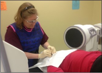 Placement of the Stealth needle™ from the head of the bed, under fluoroscopic control. (Image courtesy of Andrea Trescot, MD)